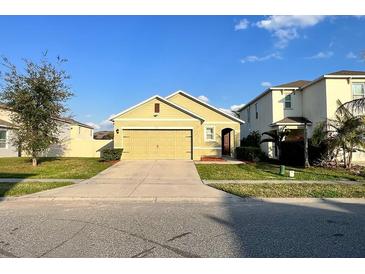 Charming single-Gathering home with a well-manicured lawn and a two-car garage with a neutral color scheme at 3211 Surfbird St, Kissimmee, FL 34744