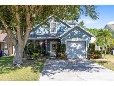 Charming home with mature shade trees, a covered front porch, and a two-car garage at 3741 Crossing Creek Blvd, St Cloud, FL 34772