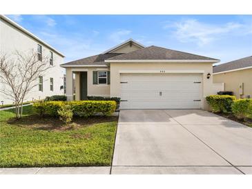 Charming single-story home with a two-car garage and well-maintained landscaping at 444 Lily Ln, Davenport, FL 33837