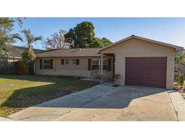 Charming single-story home featuring a well-manicured lawn and a convenient attached garage at 5445 Marvell Ave, Orlando, FL 32839