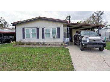 Charming single-story home with a covered carport and well-maintained front lawn at 6332 Bayberry Ne Blvd, Winter Haven, FL 33881