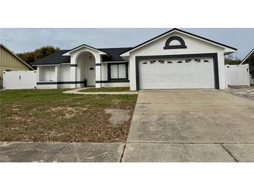 Charming single-story home with a well-manicured lawn and a two-car garage at 7860 Kensingham Ct, Orlando, FL 32835