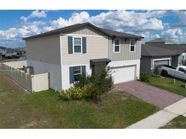 Charming two-story home featuring a two-car garage and well-maintained landscaping at 953 Cambridge Dr, Winter Haven, FL 33881