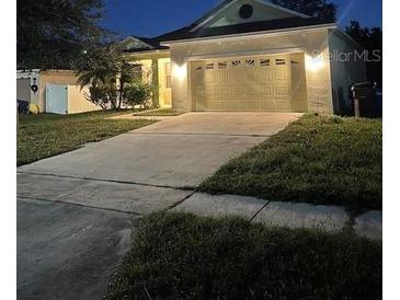 Charming one-story home featuring a two-car garage and well-maintained lawn at 3470 Goldeneye Ln, St Cloud, FL 34772