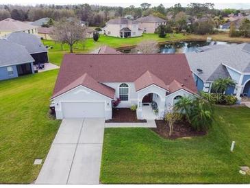 Well-maintained home with a two-car garage, driveway, lush green lawn, and professional landscaping at 4119 Maidu Ct, St Cloud, FL 34772