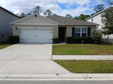 Charming single Gathering home featuring a well-maintained lawn, a two-car garage, and a cozy, inviting entrance at 5295 Timberland Ave, St Cloud, FL 34771