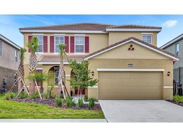 Charming two-story home with a well-manicured lawn, two car garage and a beautiful neutral color scheme at 7622 Oakmoss Loop, Davenport, FL 33837