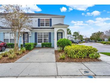 Charming two-story townhome with blue shutters and well-maintained landscaping at 7682 Fitzclarence St, Kissimmee, FL 34747