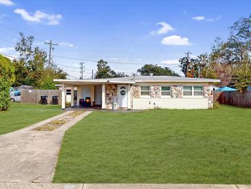 Charming single-story home with a well-maintained lawn, stone accents, and a convenient covered carport at 8101 Dominguin St, Orlando, FL 32817