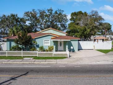 Charming single-story home with a well-maintained front yard and white picket fence at 901 W Donegan Ave, Kissimmee, FL 34741