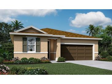 Charming single-story home featuring a well-maintained lawn and a two-car garage at 1131 Olivine Ave, Dundee, FL 33838