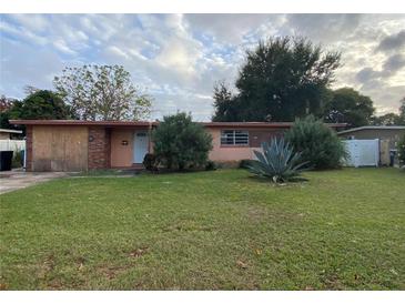 Charming single-story home with a brick exterior and well-maintained lawn at 6144 Shenandoah Way, Orlando, FL 32807