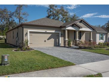 Charming single-Gathering home featuring a two-car garage and beautifully landscaped front yard at 899 Asterfield Ln, Deland, FL 32720