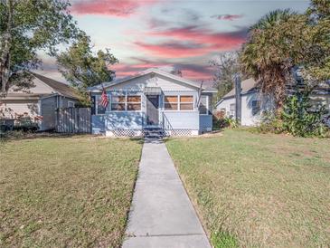 Charming single-story home featuring a quaint front porch and well-maintained lawn at 1418 Florida Ave, St Cloud, FL 34769