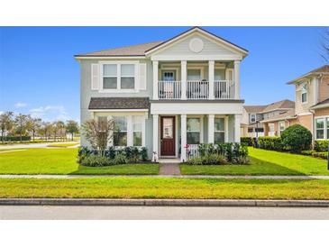 Charming two-story home featuring a welcoming porch and manicured front lawn at 2800 Cello Ln, Kissimmee, FL 34741