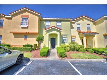 Charming townhome with colorful facade, well-maintained landscaping, and convenient parking at 500 Monroe Cir, Davenport, FL 33896