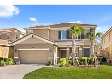 Charming two-story home featuring a tile roof, well-manicured lawn and two-car garage at 5117 Oakbourne Ave, Davenport, FL 33837