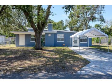 Charming single-story home with a covered parking area and well-maintained front yard at 1006 San Domingo Rd, Orlando, FL 32808