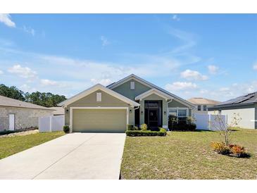 Charming single-story home with well-maintained lawn and a two-car garage at 1238 James Ln, Kissimmee, FL 34759