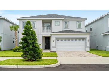 Charming two-story home with landscaped yard and a two car garage at 194 Golden Noble St, Davenport, FL 33897