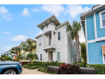 Charming two-story home with a balcony and landscaped yard, perfect for enjoying the coastal lifestyle at 8012 Lost Shaker Ln, Kissimmee, FL 34747