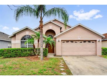 Charming single-story home with a well-manicured lawn and inviting curb appeal at 923 Tramells Trl, Kissimmee, FL 34744