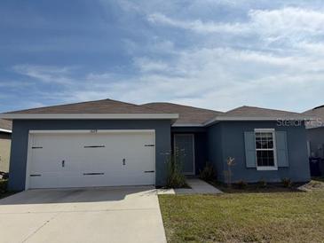 Charming single-story home featuring a two-car garage and well-maintained lawn at 1629 Ambar Ct, Winter Haven, FL 33881