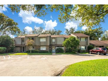 Well-maintained townhouse complex featuring a lush green landscape and ample parking space for residents and visitors at 406 Oak Haven Dr # 406, Altamonte Springs, FL 32701