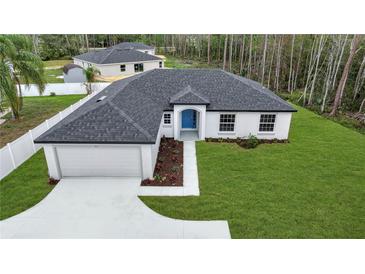 New construction home with a well manicured lawn and a two car garage at 41 Peterlee Ct, Kissimmee, FL 34758
