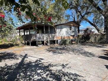 Charming single-story home featuring a covered porch and a spacious front yard at 413 4Th St, Orlando, FL 32824