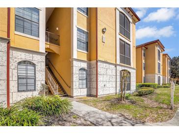 Charming condo exterior showing walkways, patios, and lush landscaping in a well maintained community at 6153 Metrowest Blvd # 103, Orlando, FL 32835