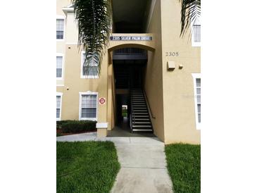 Building exterior featuring well-maintained landscaping and visible unit address at 2305 Silver Palm Dr # 102, Kissimmee, FL 34747