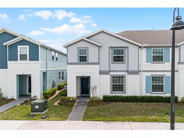 Charming two-story townhome with well-manicured landscaping and a welcoming front entrance at 281 Jetty Way, Davenport, FL 33897