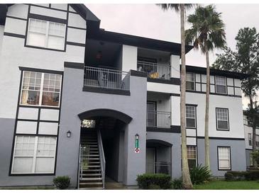 Three-story apartment building showcasing an elegant facade with balconies and well-maintained landscaping at 3712 Castle Pines Ln # 4126, Orlando, FL 32839