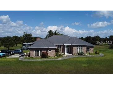 Charming single-story home with manicured lawn, mature trees, and a well-maintained exterior at 4261 Twilight Trl, Kissimmee, FL 34746