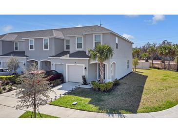 Charming two-story townhouse featuring an attached garage, well-maintained landscaping, and a welcoming front entrance at 4544 Teoli Ct, Kissimmee, FL 34746
