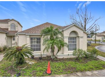 Well-kept home featuring desert landscaping, concrete walkway, and covered porch at 734 Olympic Cir # 30, Ocoee, FL 34761