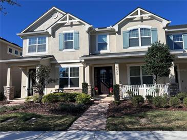 Charming two-story home with blue shutters, front porch, and manicured landscaping at 8628 Dufferin Ln, Orlando, FL 32832