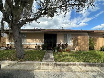 Charming single-story home with a well-manicured lawn and mature tree, offering shade and curb appeal at 996 Dolphin Dr, Winter Garden, FL 34787