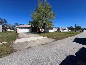 Charming single-story home with a well-maintained front lawn and a concrete driveway at 138 Inconnu Ct, Kissimmee, FL 34759