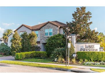 Beautiful two-story home in Lake Preserve with stone accents and lush landscaping at 3100 Stonewyck St, Orlando, FL 32824