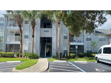 Condo building exterior with mature landscaping and convenient parking at 709 Secret Harbor Ln # 213, Lake Mary, FL 32746