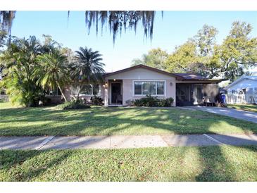 Charming single-story home featuring a well-manicured lawn and mature landscaping, offering great curb appeal at 10 Massachusetts Ave, St Cloud, FL 34769