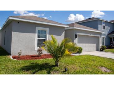 Well-maintained home exterior showcasing a manicured lawn and lush landscaping at 1228 Haines Dr, Winter Haven, FL 33881