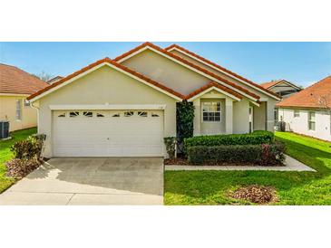 Charming single-Gathering home showcasing a well-manicured front lawn and attached two-car garage at 151 Saragossa Ave, Davenport, FL 33897
