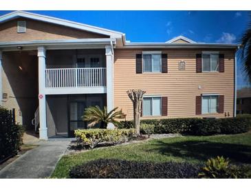 Charming townhouse exterior with a well-manicured lawn and balcony at 175N Pearl Lake Cswy # 114, Altamonte Springs, FL 32714
