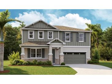 Charming two-story home featuring stone accents, a covered porch, and an attached two-car garage at 3733 Deer Ridge Dr, Mount Dora, FL 32757
