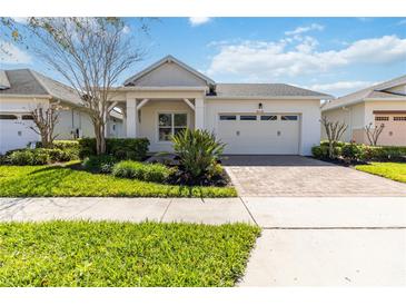 Charming single-story home boasting a manicured lawn, paver driveway, and an attached two-car garage at 4918 Drawdy Ct, St Cloud, FL 34772