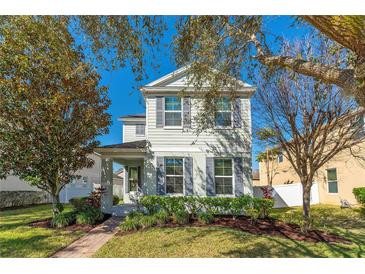 Charming two-story home with gray shutters and well-maintained landscaping at 6054 Roseate Spoonbill Dr, Windermere, FL 34786