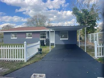 Charming single-story home with a well-maintained front yard, carport, and classic white picket fence at 736 Nw 31St Ct, Winter Haven, FL 33881